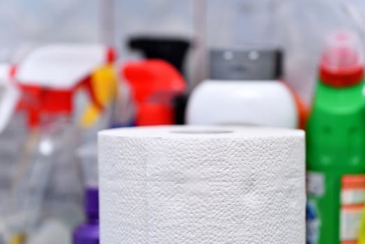 White paper roll with cleaning products photo