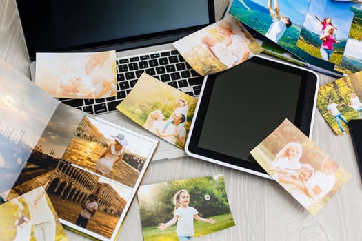 LAPTOP COMPUTER ON A DESK WITH PHOTO ALBUM