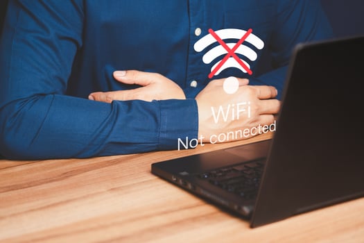 Man using a computer laptop to connect to wifi but wifi not connected, and waiting to loading digital business data form website, concept technology of waiting for connect to wifi. photo
