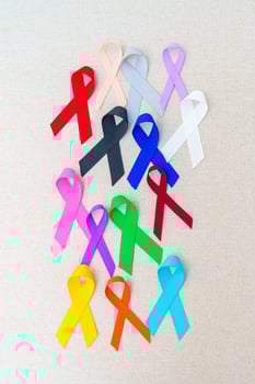 World cancer day, February 4. Colorful ribbons for supporting people living and illness. Healthcare, fighting, medical and National Cancer Survival day, Autism awareness day concept photo