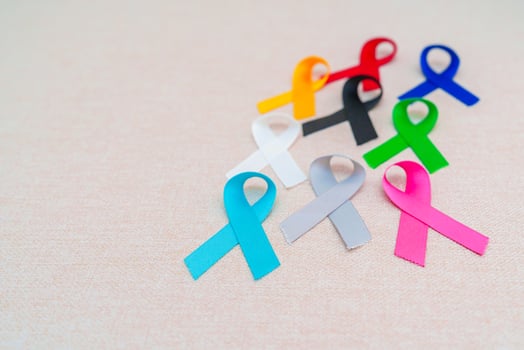 World cancer day, February 4. Colorful ribbons for supporting people living and illness. Healthcare, fighting, medical and National Cancer Survival day, Autism awareness day concept photo
