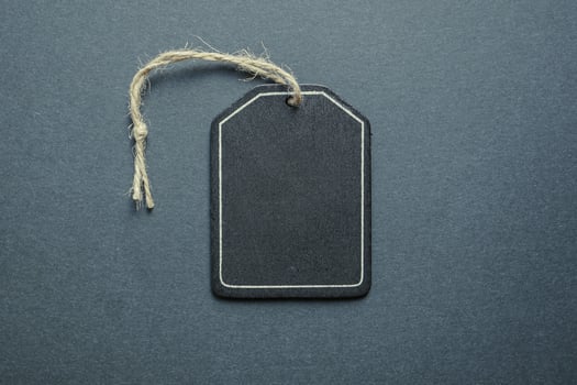 black price tag on the black background, black mockup photo