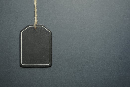 black price tag on the black background, black mockup photo