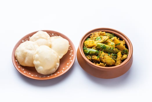 Aloo Patol sabzi made using pointed gourd and potato served with fried Luchi or poori, Bengali food photo