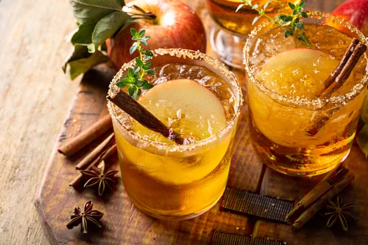 Apple cider margarita with brown sugar rim and cinnamon stick photo