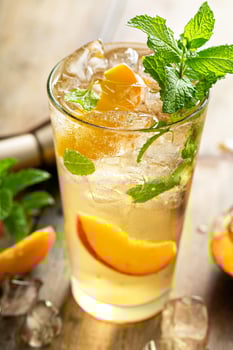 Summer peach mojito cocktail with fresh mint, lime and peach slices photo