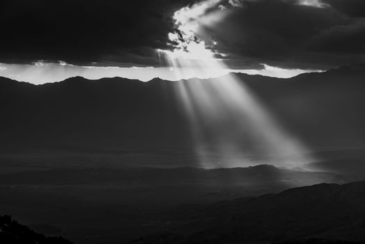 Image of a spectacular weather scene with impressive sun rays through a hole in the clouds photo