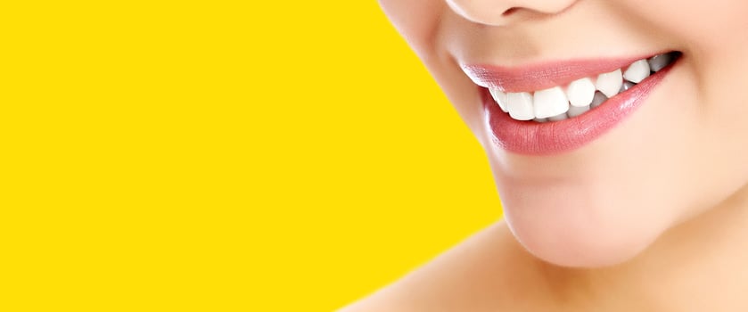 Pretty woman smiling against a yellow background with copyspace photo