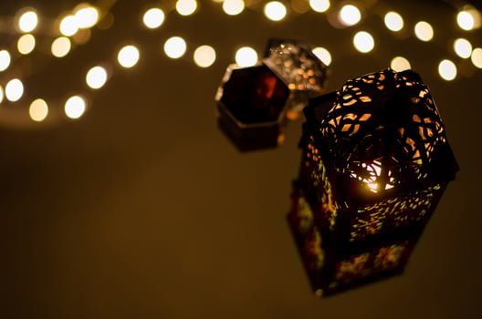 Selective focus of lantern with dates fruit reflection from bokeh light for the Muslim feast of the holy month of Ramadan Kareem. photo