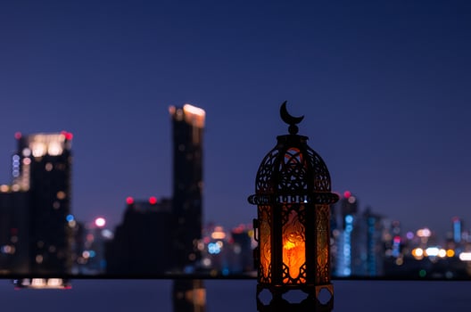 Lantern that have moon symbol on top with night city background for the Muslim feast of the holy month of Ramadan Kareem. photo