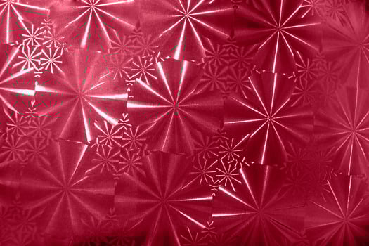 Abstract pattern with round segments with rays on holographic paper in color 2023 Viva Magenta. photo