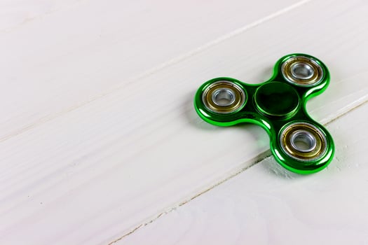 Close up shot of an green fidget spinner photo