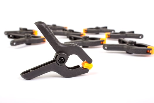 Clothespin. Carpentry clamps. Plastic clothespin on a white. photo