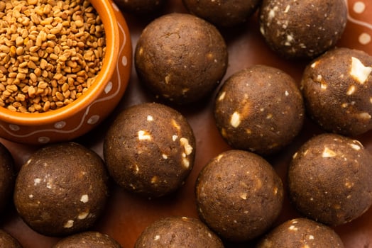 Fenugreek or methi ke Laddu, laddo or laddoo or sweet mithai balls for boosting immunity in winters photo