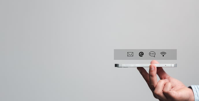 Businesswoman using phone and touching on virtual screen contact icons such as email, address, live chat, internet wifi. Contact us or Customer support hotline people connect. Connect with cyberspace. photo