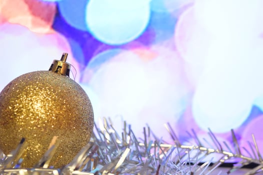 Christmas toy. Christmas decoration, gold ball Christmas decorations with tinsel on a light background. Conception Christmas and New Year. photo