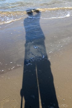 Photographer's shadow on the seashore. photo