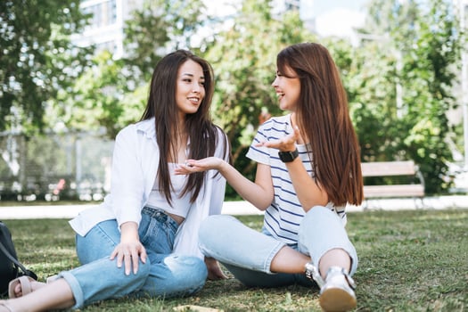Young beautiful asian girls with long hair in casual clothes, friends having fun in city park photo