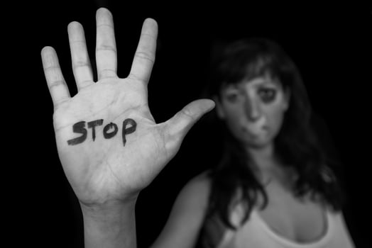 Stop violence against women. Woman with mouth closed by patch and hand written stop photo
