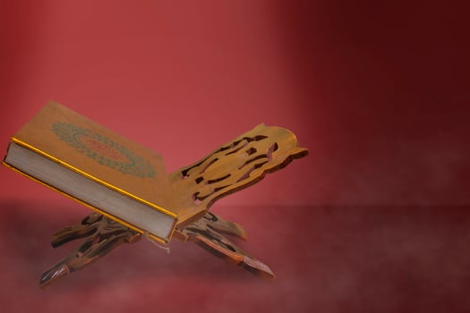 holy book quran on red background photo