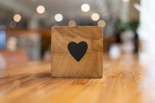 Wooden blocks with symbol of heart dating concept. cubes of wooden blocks, with icons and copy space photo