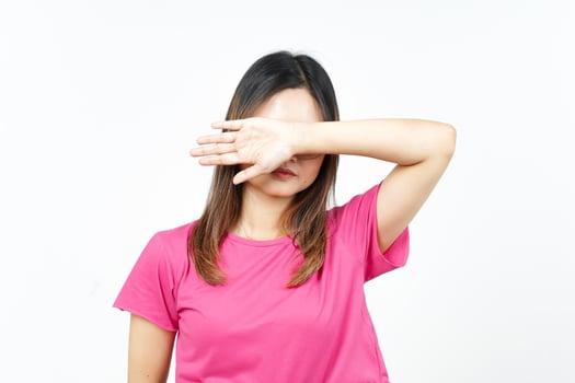 Covering Eyes With Arms Of Beautiful Asian Woman Isolated On White Background photo