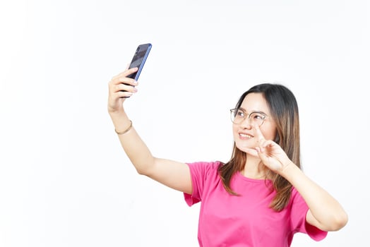 Take a Selfie using Smartphone Of Beautiful Asian Woman Isolated On White Background photo