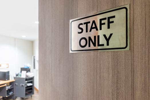 Warning sign in front of the door with a message for staff only with inside the sound control room. photo