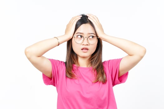 Hands on Head with WOW Face Expression Of Beautiful Asian Woman Isolated On White Background photo
