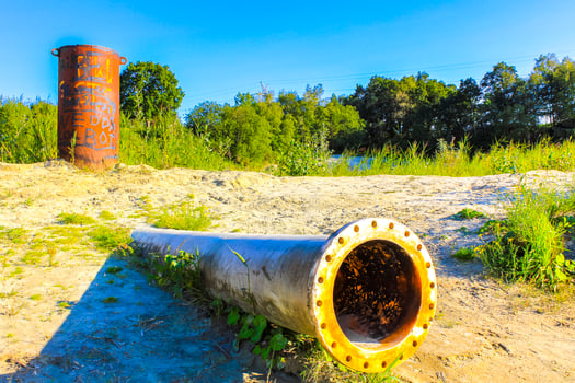 Huge drain pipe at quarry pond in Germany. photo