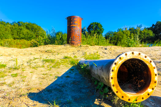 Huge drain pipe at quarry pond in Germany. photo