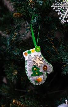 Creative diy craft hobby. Making handmade craft christmas ornaments and balls with felt spruce tree. christmas tree with colorful balls and gift boxes over white brick wall with blue and white balls photo