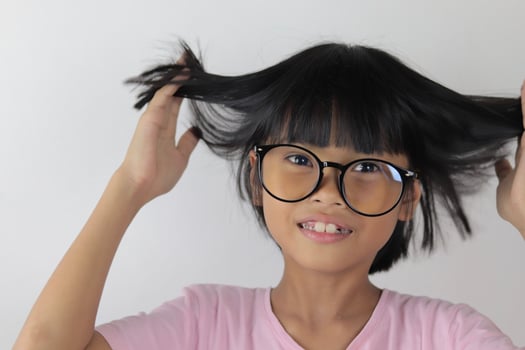 Portrait of child wearing eyeglasses on white background photo