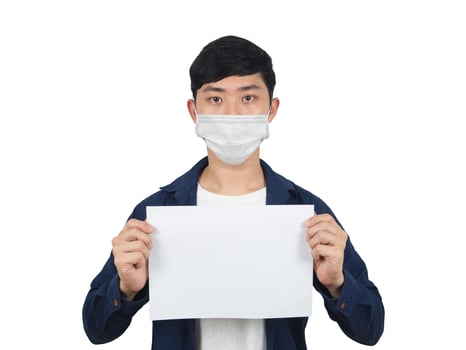 Asian man with mask serious face show blank paper up looking at camera covid-19 concept photo