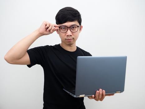 Handsome man holding laptop touch his glasses confident face businessman concept on white background photo