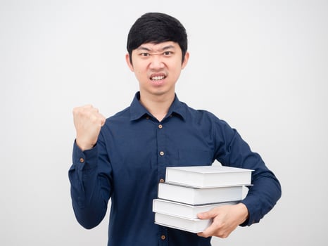 Asian man confident show fist up and holding book in hand portrait white background photo