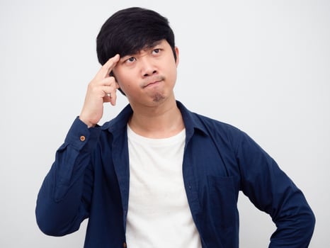 Portrait asian man thinking something touch his head serious face photo