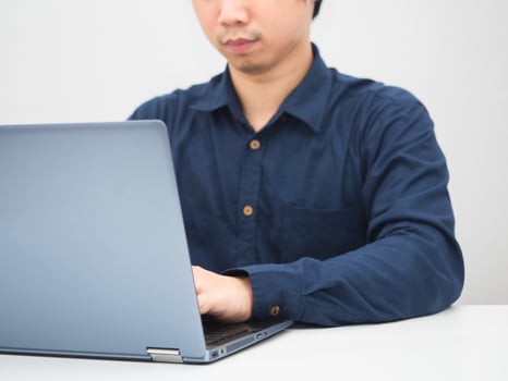 Man sitting at the desk using laptop for work white background photo