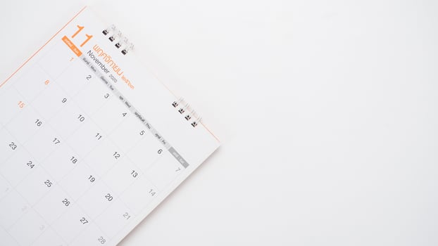 Close up calendar on the white table top view copy space photo