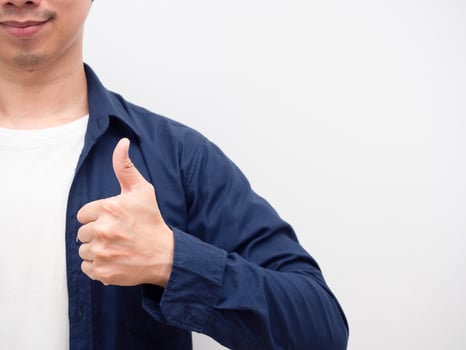Portrait asian man thumb up with smile at face crop body with copy space white background photo