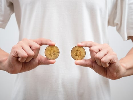 Close up man white shirt show golden bitcoins in his hand photo