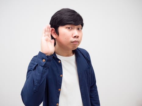 Young man show hand at his ear want to heard,Asian man Listening concept photo