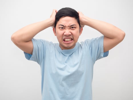 Angry man touch his head feeling mad emotion white isolated photo
