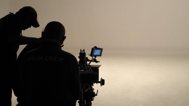 Silhouette of working people or production film crew are making movie or shooting. photo