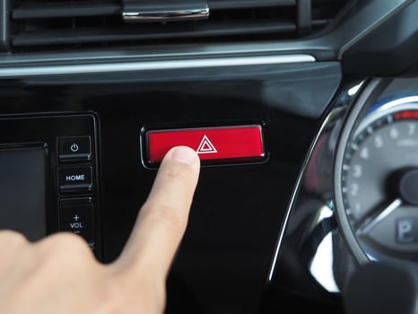 Finger at the emergency button of car shiny and clean photo