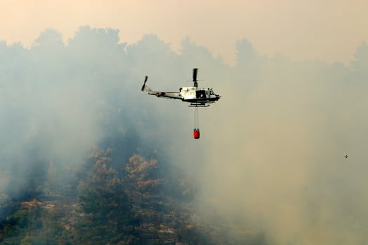 A helicopter puts out a forest fire in the mountains of northern Israel. photo