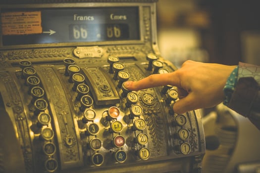 Close up woman pressing key of old cash register concept photo