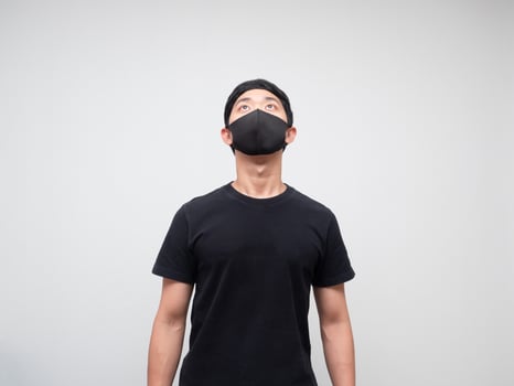 Portrait asian man with protect mask looking up to space on white background photo