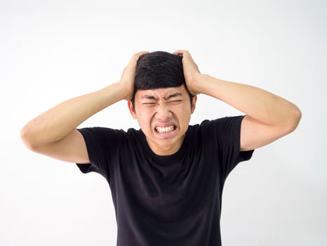 Asian man very headache touch head two hand sad at face black shirt on white isolate background portrait photo