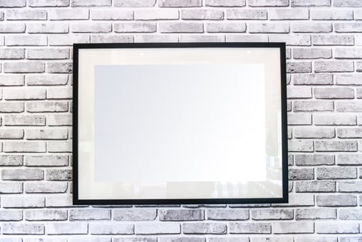 Blank picture frame hanging on wall photo